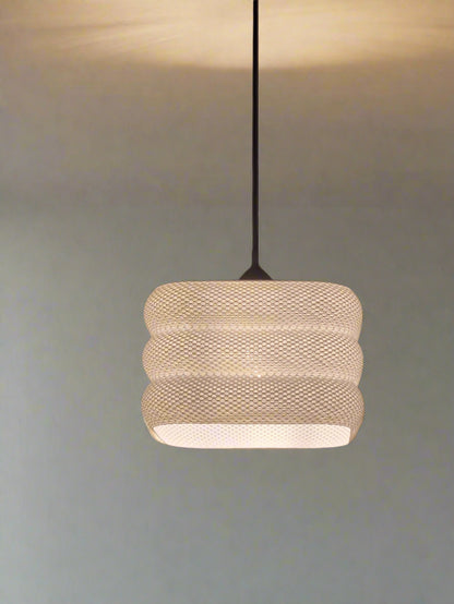 Modern light fixture with a textured design on a blurred background